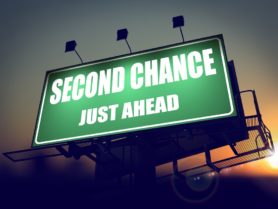Second Chance Just Ahead - Green Billboard on the Rising Sun Background.